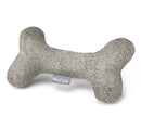 Puppy cuddling with soft wool Calma bone toy in subtle color